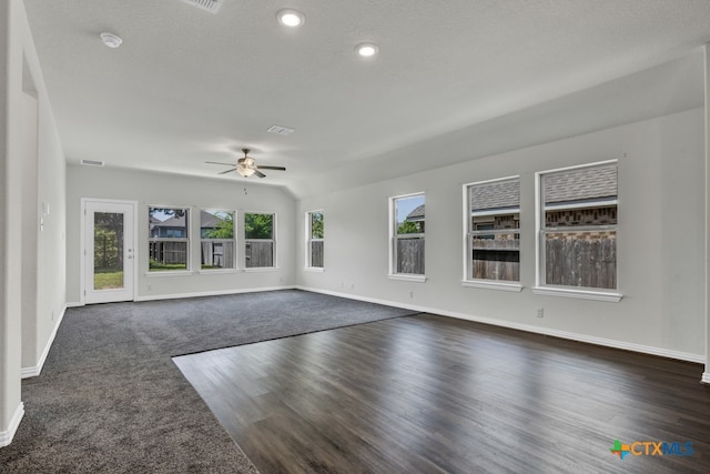 unfurnished living room featuring ceiling fan, dark hardwood / wood-style floors, and a textured ceiling