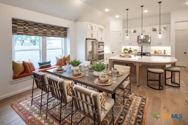 dining space with light wood-style floors, baseboards, and recessed lighting
