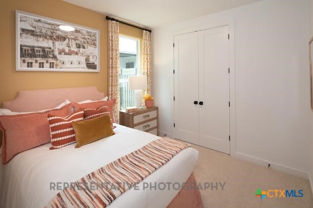 bedroom with carpet flooring, baseboards, and a closet