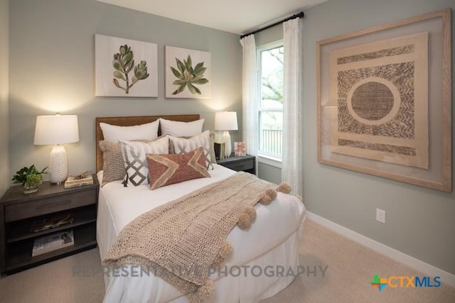 bedroom featuring baseboards and carpet flooring