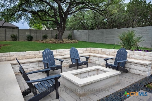 view of patio featuring a fenced backyard and an outdoor fire pit