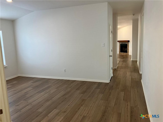 512 Constellation Dr, Killeen, TX 76542 - empty room with dark wood finished floors, a tile fireplace, and lofted ceiling