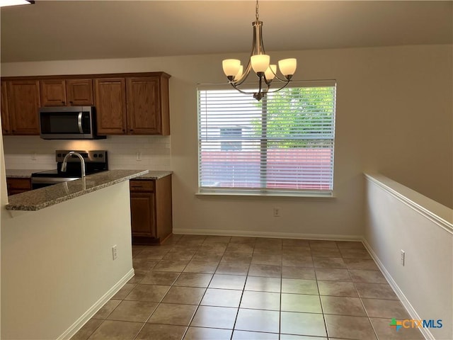512 Constellation Dr, Killeen, TX 76542 - kitchen featuring stainless steel microwave, electric stove, tasteful backsplash, a chandelier, and light tile patterned floors