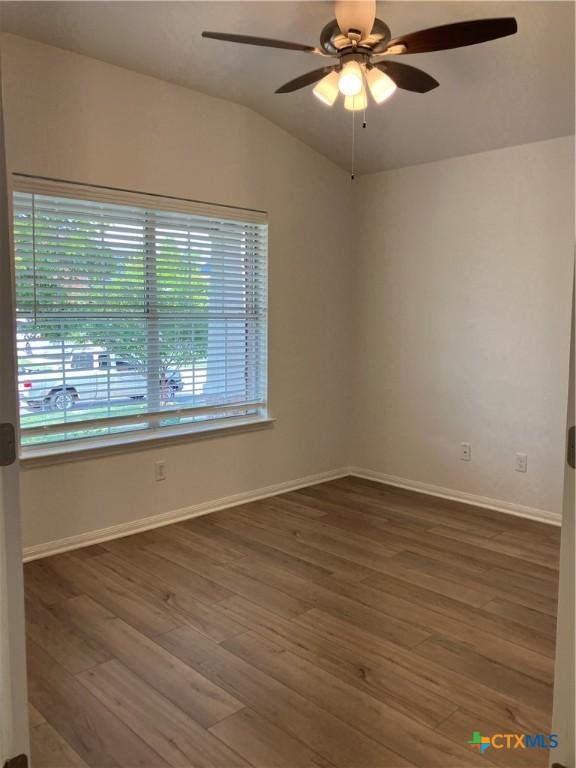 512 Constellation Dr, Killeen, TX 76542 - spare room featuring a ceiling fan, wood finished floors, and vaulted ceiling