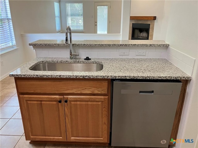 512 Constellation Dr, Killeen, TX 76542 - kitchen with dishwasher, light stone counters, and brown cabinetry