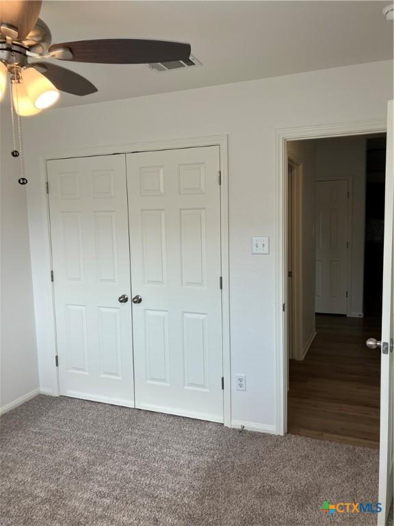 512 Constellation Dr, Killeen, TX 76542 - unfurnished bedroom featuring carpet, a closet, and ceiling fan