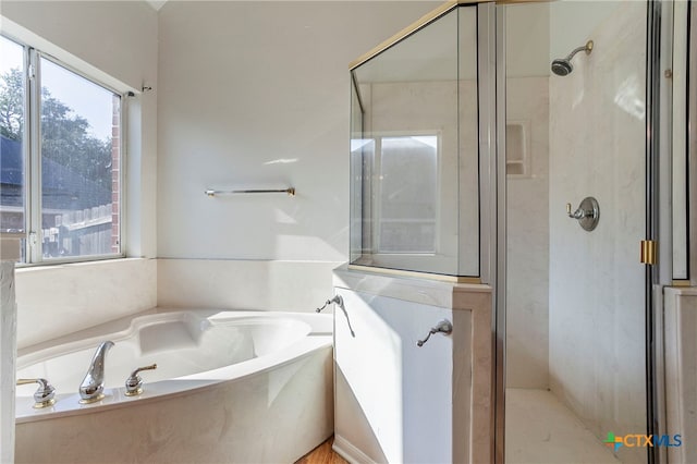 bathroom with shower with separate bathtub