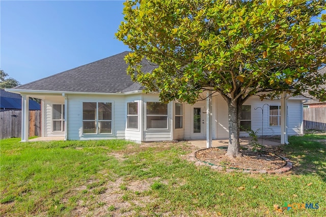 rear view of property with a yard