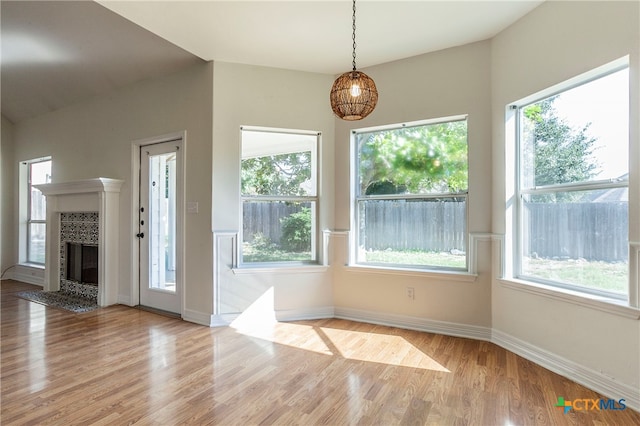 unfurnished dining area with light hardwood / wood-style floors and a healthy amount of sunlight