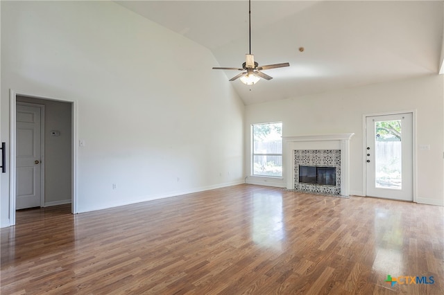 unfurnished living room featuring hardwood / wood-style flooring, ceiling fan, and high vaulted ceiling