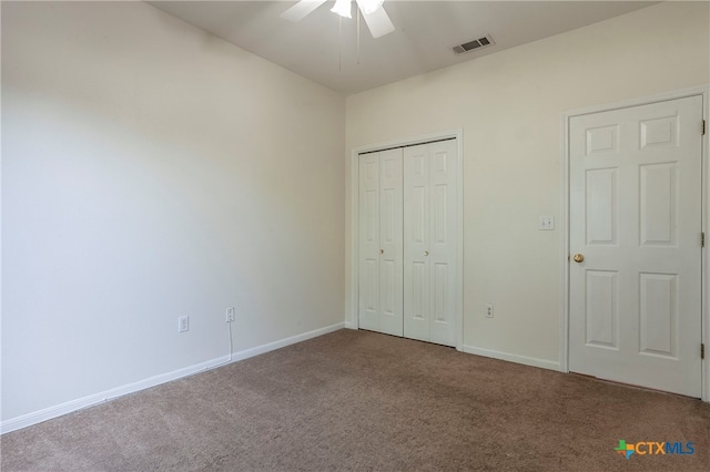 unfurnished bedroom with a closet, carpet flooring, and ceiling fan