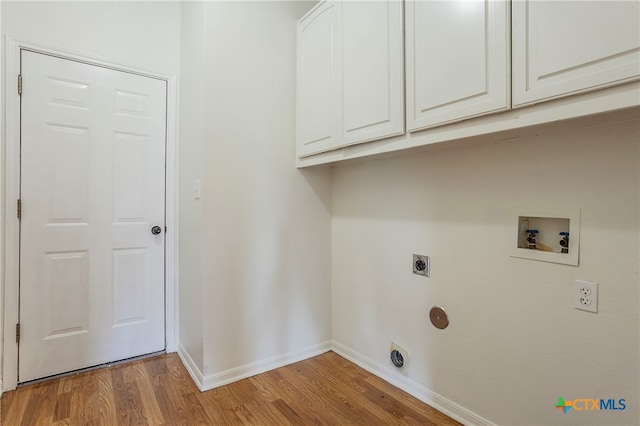 clothes washing area with light wood-type flooring, electric dryer hookup, washer hookup, and cabinets