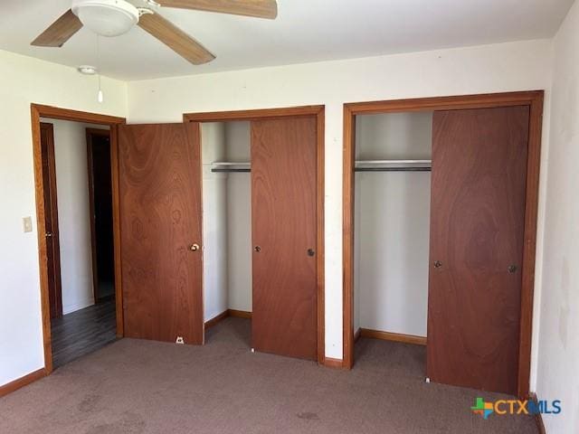 unfurnished bedroom with ceiling fan, baseboards, carpet flooring, and multiple closets