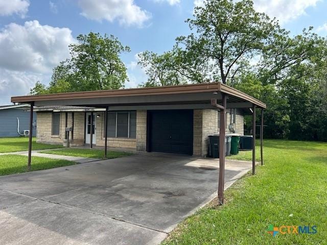 ranch-style home with a garage, stone siding, driveway, and a front yard