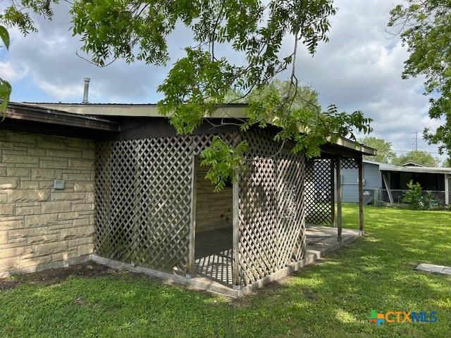 view of outbuilding with fence