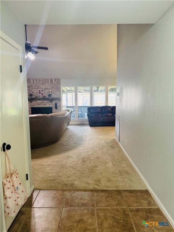 hall with dark colored carpet