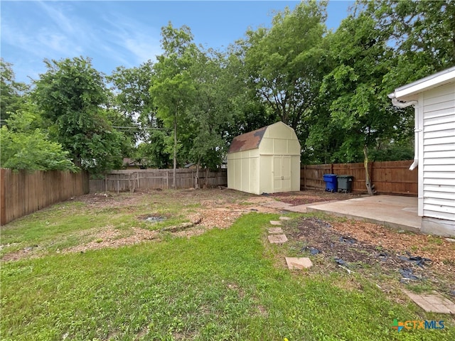 view of yard with a shed and a patio