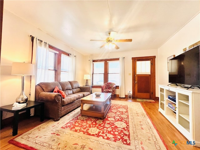 living room with hardwood / wood-style floors and ceiling fan