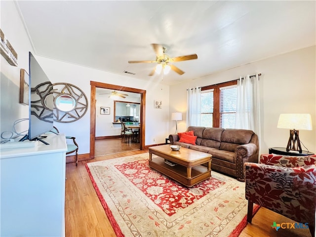 living room with hardwood / wood-style floors and ceiling fan