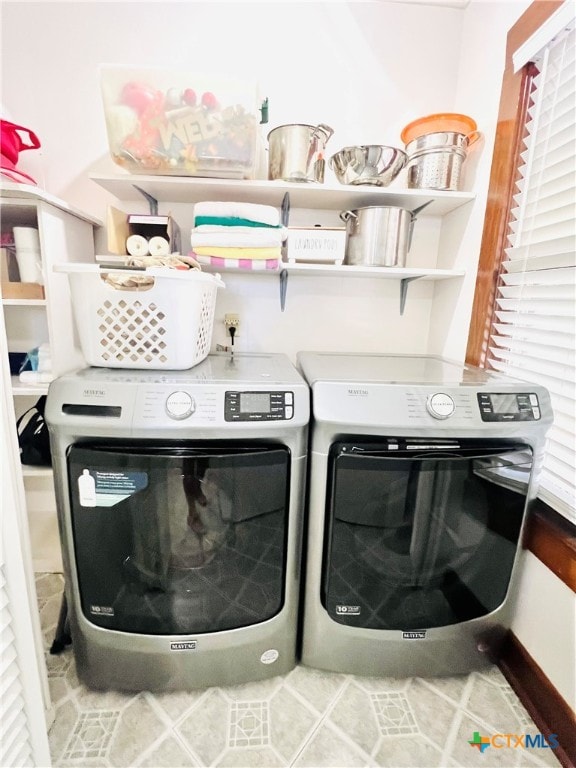 laundry area featuring tile patterned floors and separate washer and dryer