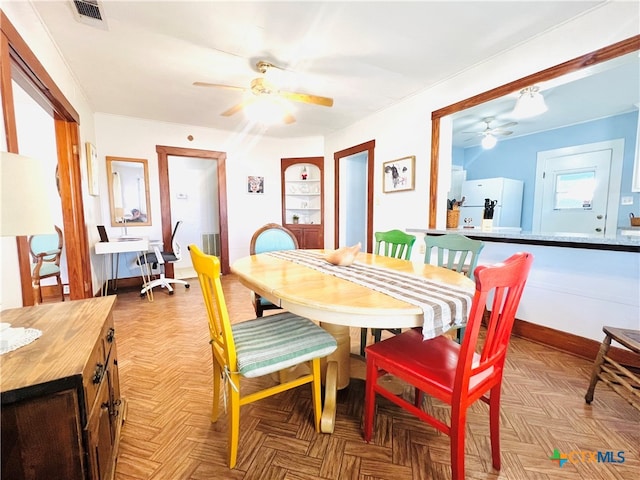 dining room featuring ceiling fan and light parquet floors