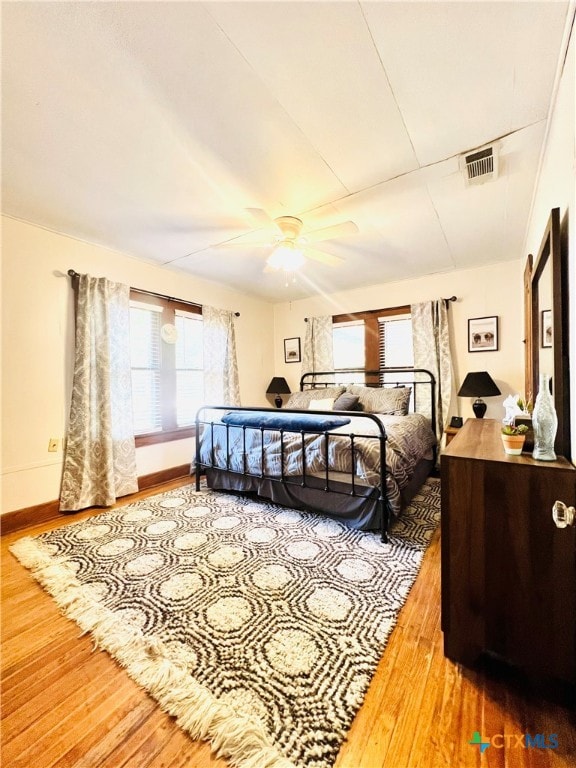 bedroom featuring hardwood / wood-style flooring and ceiling fan