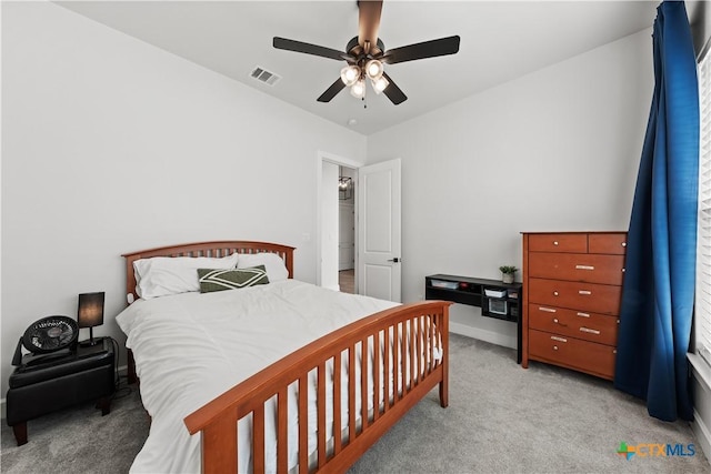 bedroom featuring visible vents, ceiling fan, and light colored carpet
