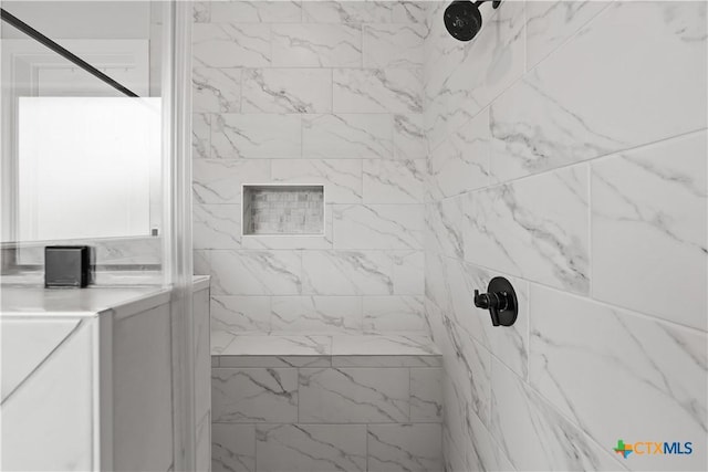 full bathroom with a marble finish shower