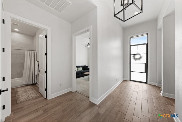 entrance foyer featuring visible vents, wood finished floors, and baseboards