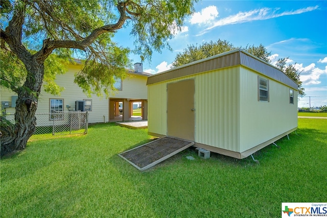 view of outbuilding with a yard