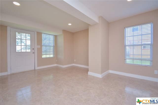 interior space featuring a healthy amount of sunlight and light tile patterned floors