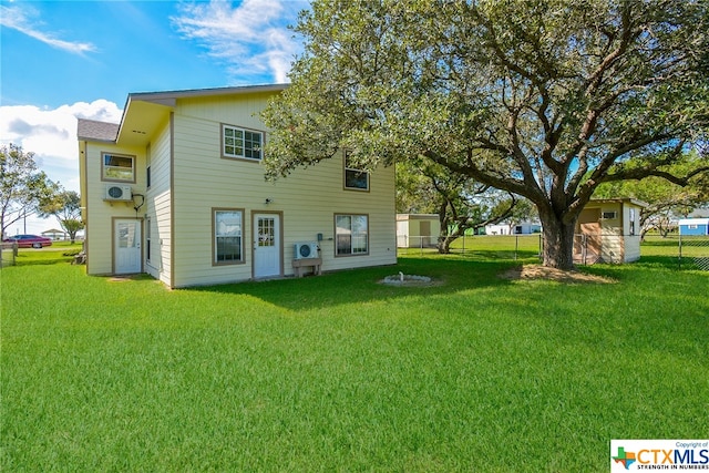 rear view of property with a yard