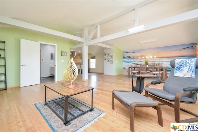 living room with wood-type flooring and vaulted ceiling with beams