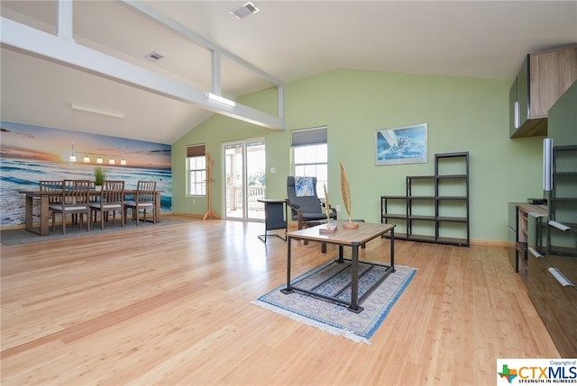 interior space featuring light wood-type flooring and vaulted ceiling