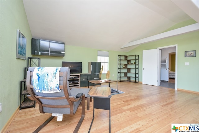 sitting room featuring lofted ceiling and light hardwood / wood-style floors