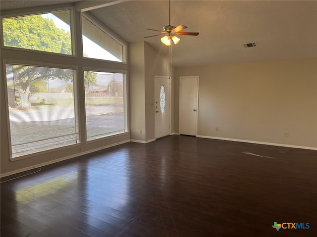 interior space with a textured ceiling, dark hardwood / wood-style flooring, high vaulted ceiling, and ceiling fan