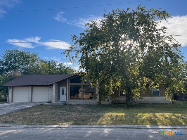 view of front of property with a front yard and a garage