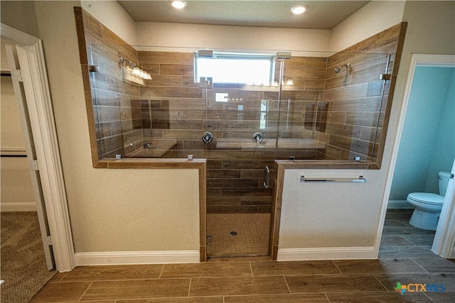 213 Fillmore Fls, Cibolo, TX 78108 - full bathroom with toilet, a shower stall, wood tiled floors, baseboards, and recessed lighting