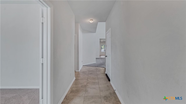 hallway with light colored carpet