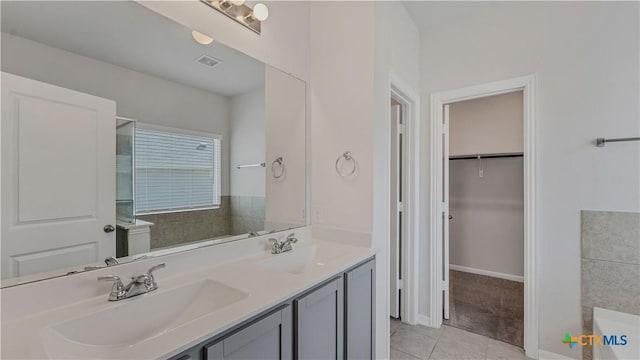 300 Jacks Pl, Seguin, TX 78155 - bathroom with tile patterned floors, double vanity, a spacious closet, a tub, and a shower