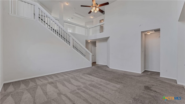 unfurnished living room with a high ceiling, ceiling fan, and light carpet