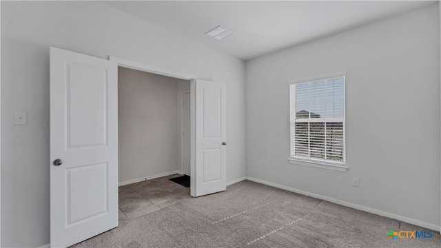 unfurnished bedroom featuring light colored carpet