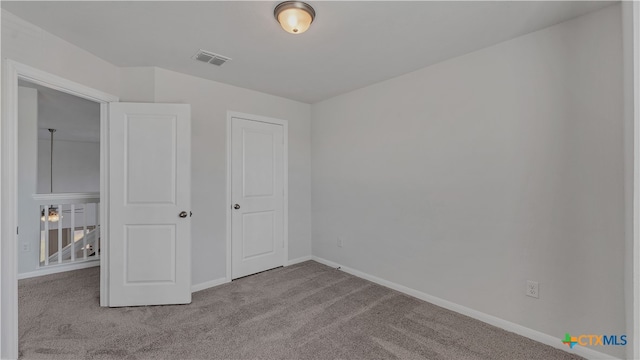 unfurnished bedroom featuring light carpet