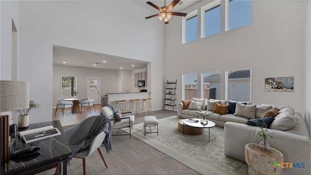 300 Jacks Pl, Seguin, TX 78155 - living room featuring a towering ceiling, a ceiling fan, light colored carpet, recessed lighting, and baseboards