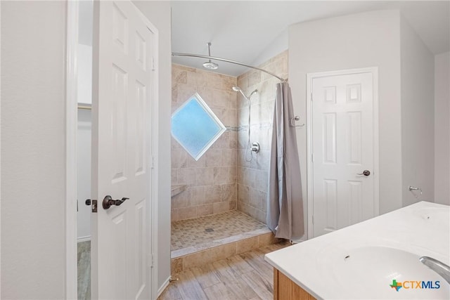 bathroom featuring vanity and tiled shower