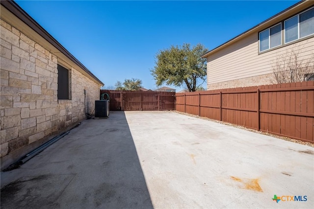 view of patio with cooling unit and a fenced backyard