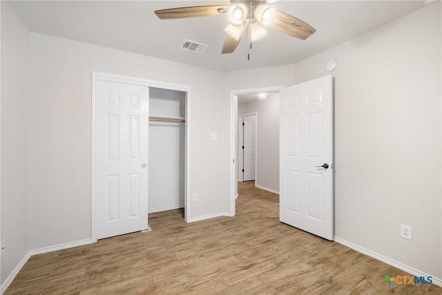 unfurnished bedroom featuring a closet, visible vents, baseboards, and light wood-style floors