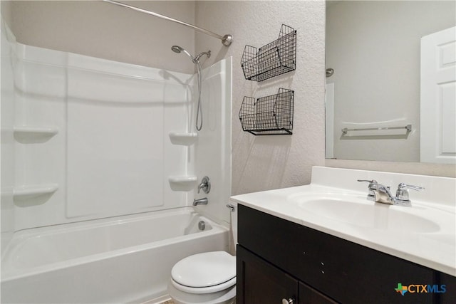 full bathroom with vanity, a textured wall, toilet, and shower / washtub combination