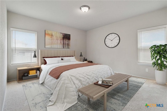 carpeted bedroom with baseboards