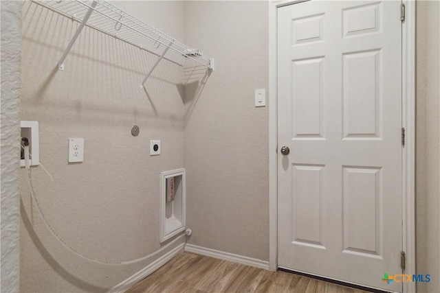 washroom with washer hookup, hookup for an electric dryer, laundry area, wood finished floors, and baseboards